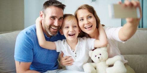 Parents and child smiling together