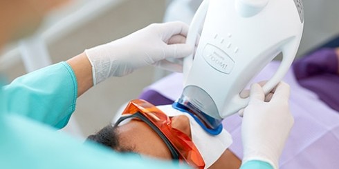 Dental patient receiving teeth whitening treatment